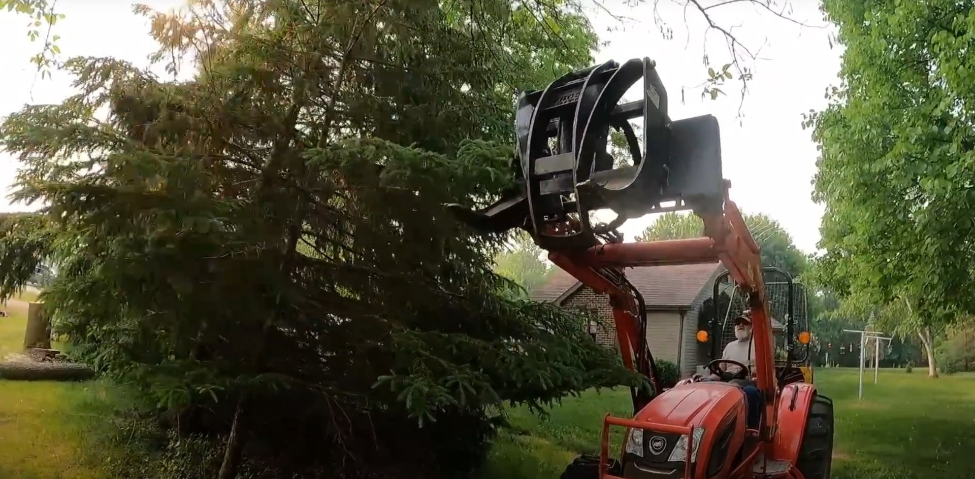 Professional Tree Removal Equipment Heavy machinery safely removing large trees near residential property